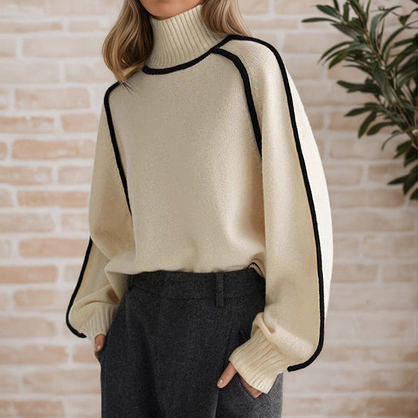 White women wearing a Ivory refined knit turtleneck sweater from the Dylan Archer women’s premium clothing collection, styled in an elegant chic style with tailored trousers in a clean studio setting.