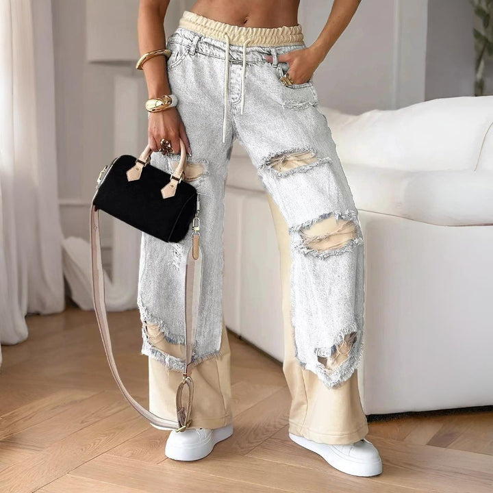 Light Grey distressed denim jogger with relaxed fit from the Dylan Archer women’s premium clothing collection, defined by an elegant chic style and a modern, effortless silhouette.