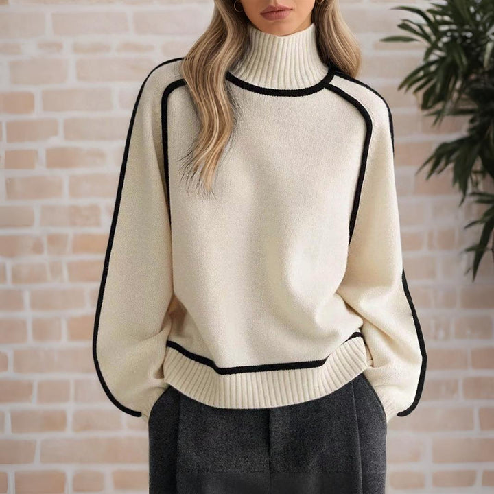 White women wearing a refined knit turtleneck sweater from the Dylan Archer women’s premium clothing collection, styled in an elegant chic style with tailored trousers in a clean studio setting.